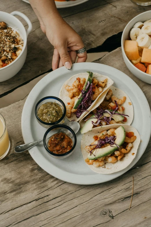 someone reaching for an item that is on a plate