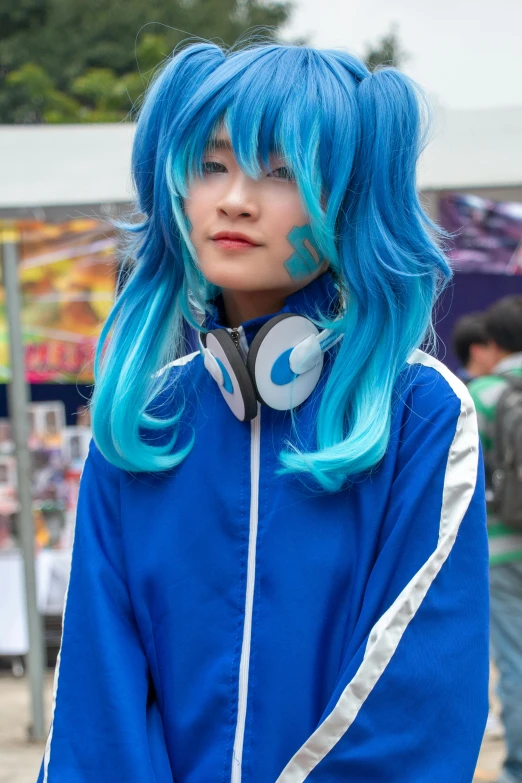 a young person with long hair and headphones on