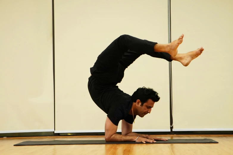 a man on a mat doing a yoga upward bend