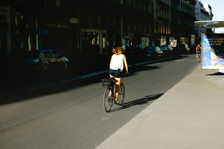 the woman rides her bicycle down the street