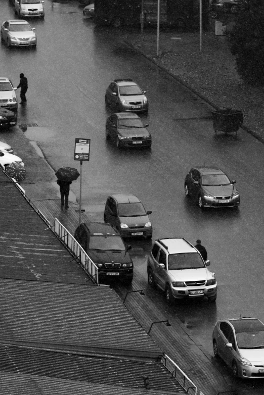 a group of cars driving down a rainy street