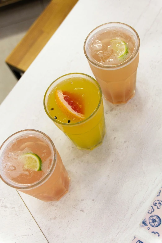 three different kinds of drinks are lined up on a table