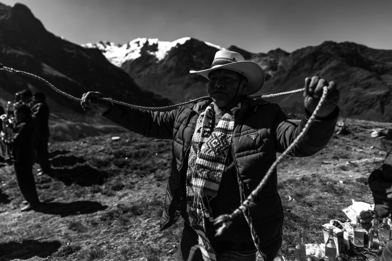 two mountaineers hold out their ropes to keep them company