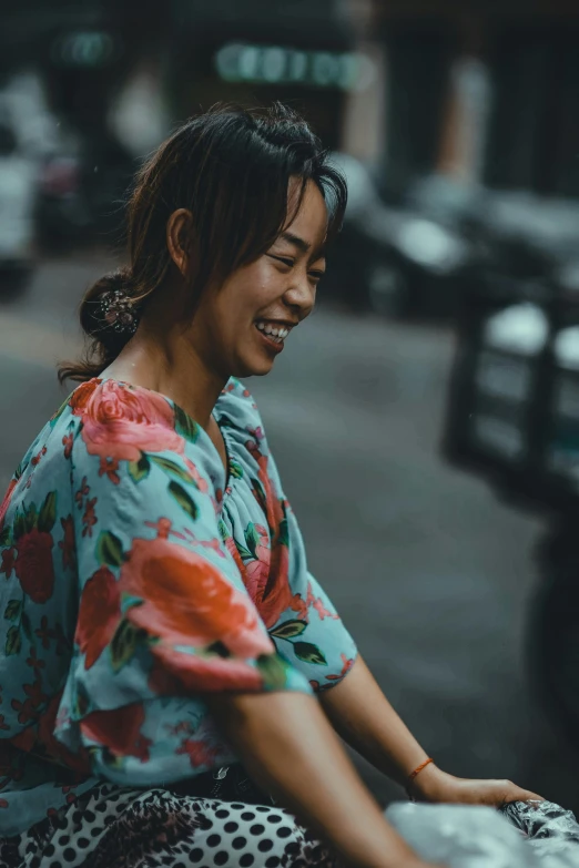 woman sitting on the curb talking on her phone