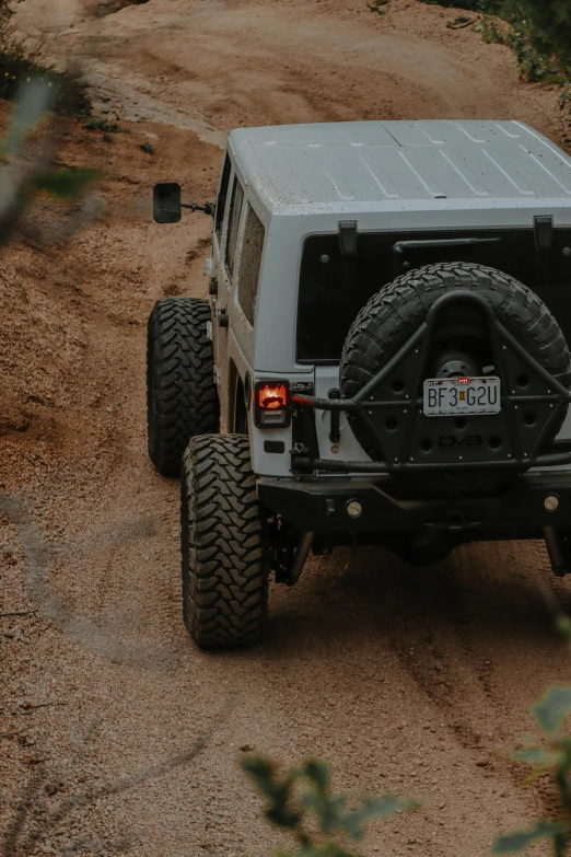 an off - road vehicle drives on a dirt path