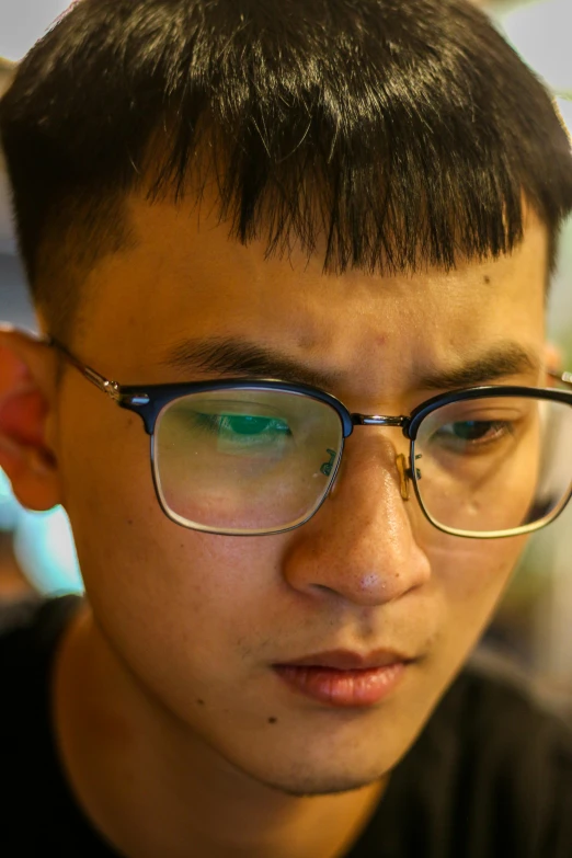a person wearing glasses is looking into the distance