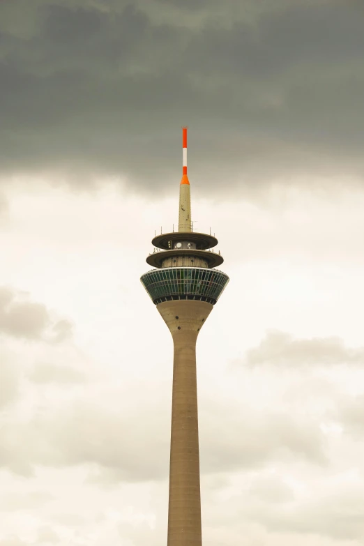 the sky tower is a tall structure with an orange arrow on it