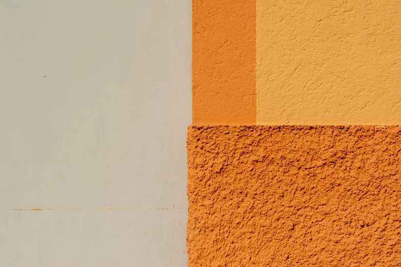 two different colors of stucco, one has orange and one white