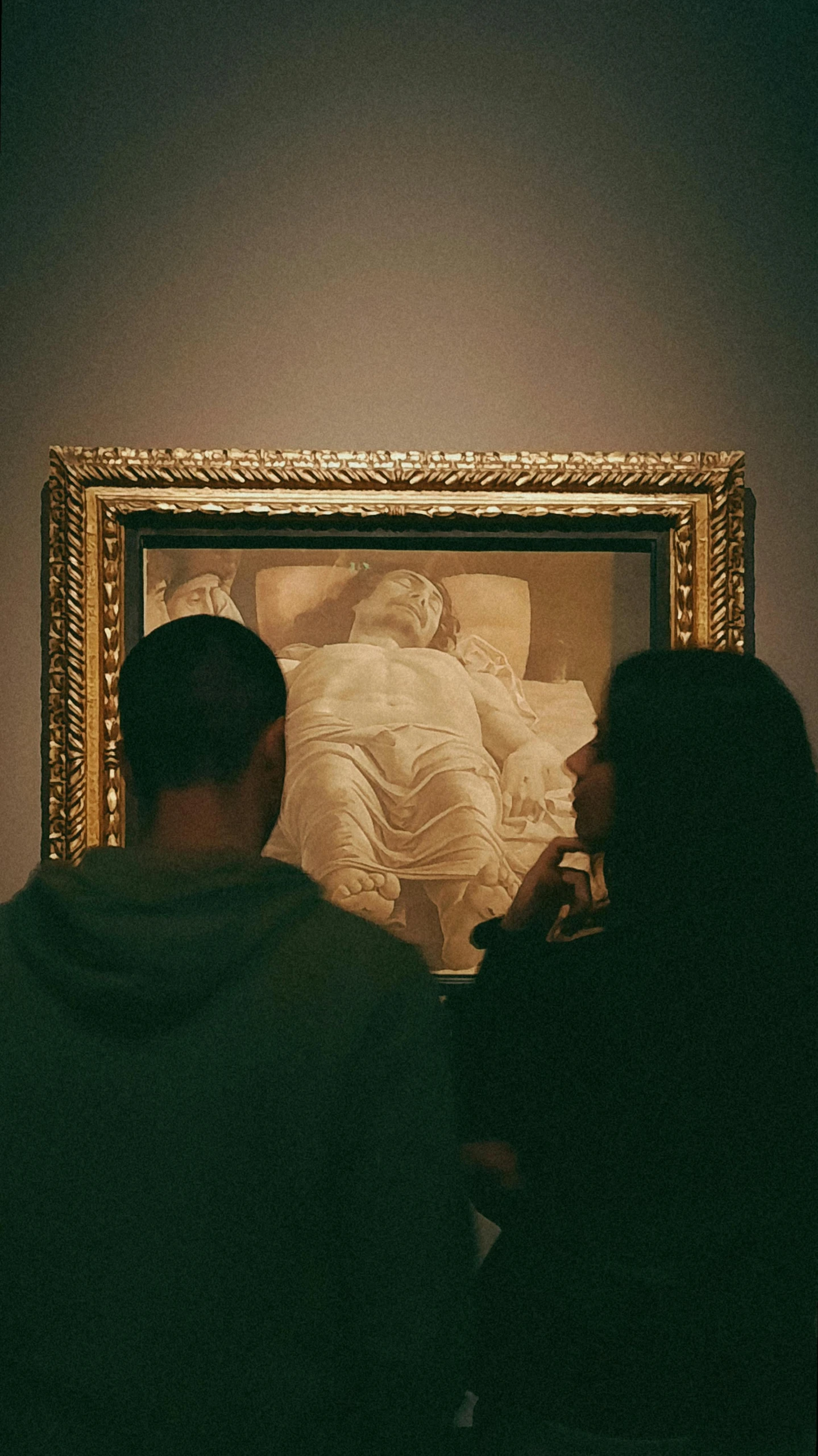 a couple looking at a painting while sitting in front of it