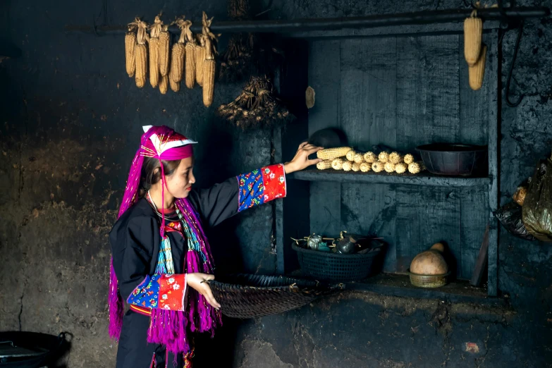 a girl in mexican attire preparing food at an antique kitchen