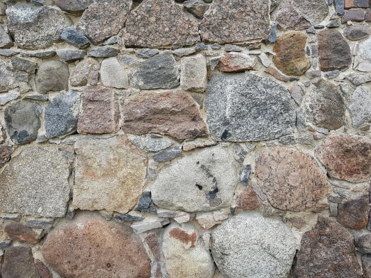 there is a very old wall that looks like it has a stone pattern on it