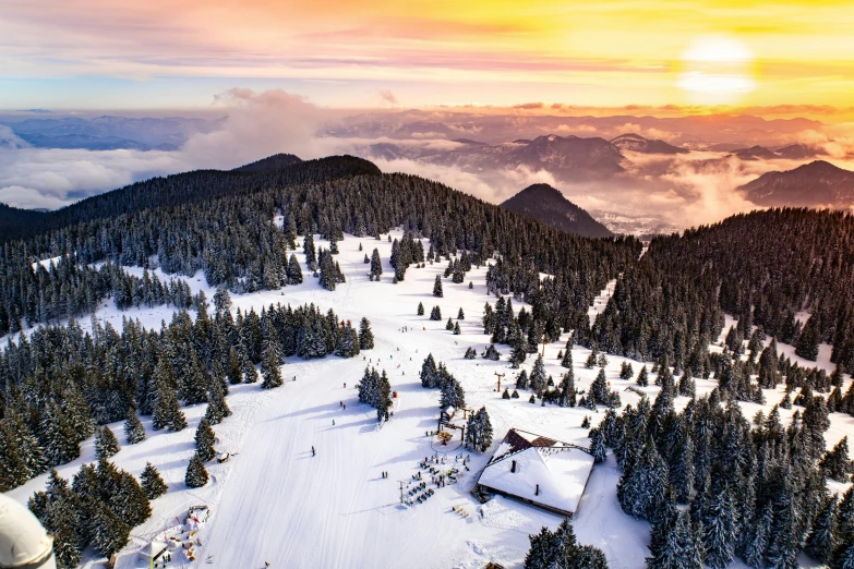 a beautiful sunset over the snow covered mountain side