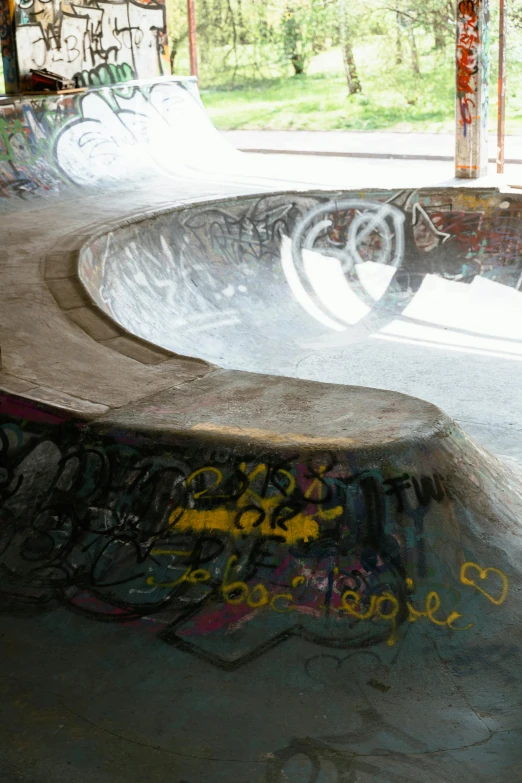 a skateboard park with graffiti on it's walls