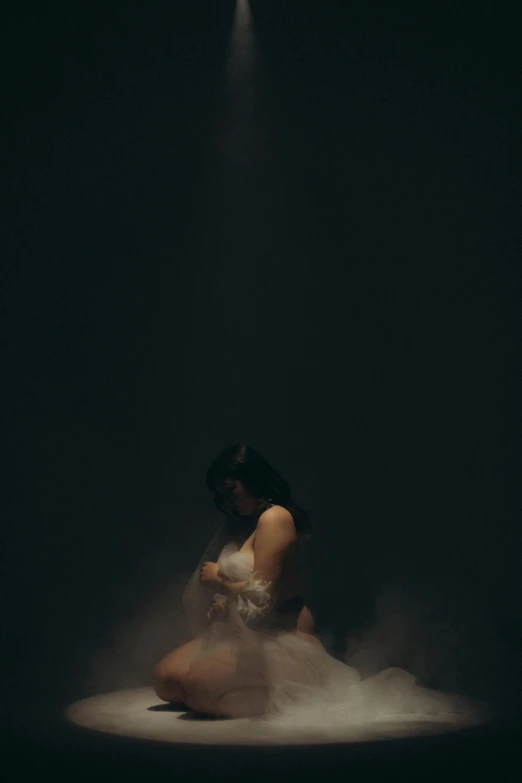 woman sitting on a floor looking at her phone