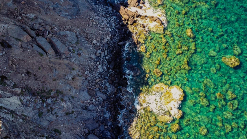 water with rocks near by and blue water