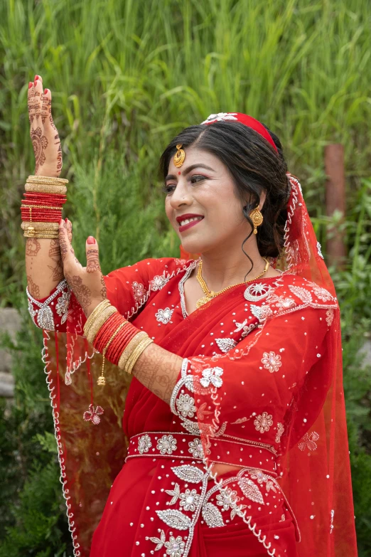 a woman in red outfit holding her hands together