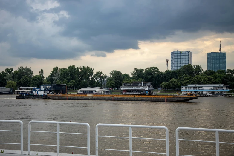 boats and some buildings on the edge of water