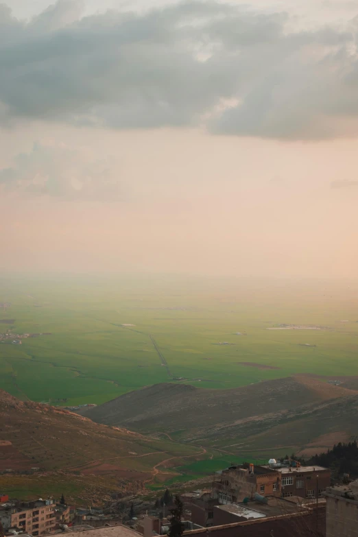 a city on the hill with a valley in the distance