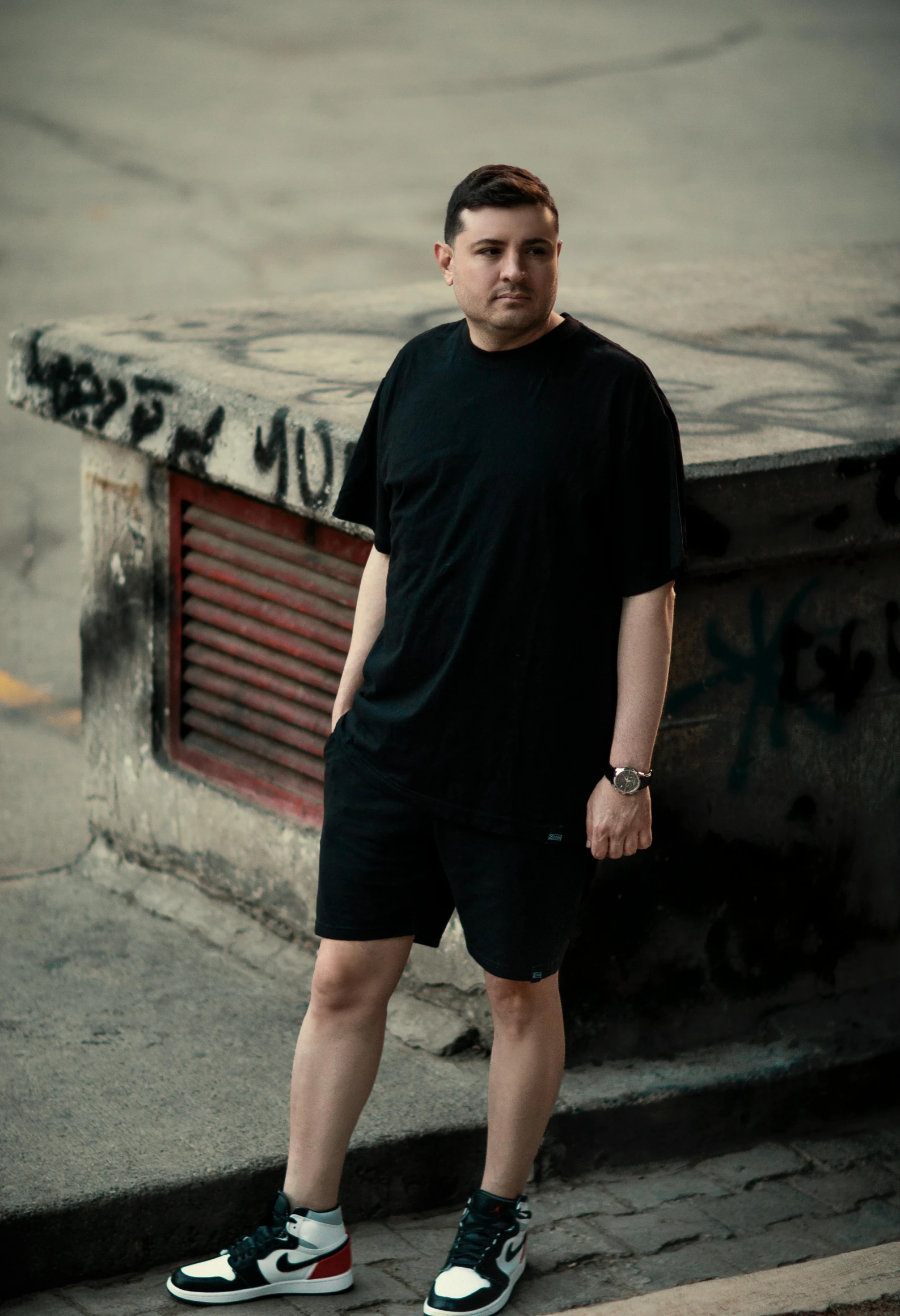 a man posing for a picture with his shoes off