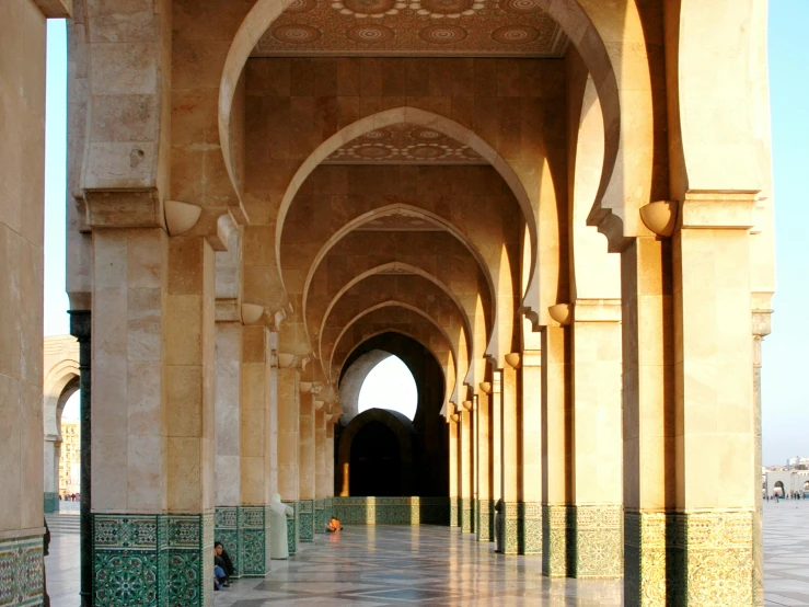 an ornate hallway with archways and marble tilework