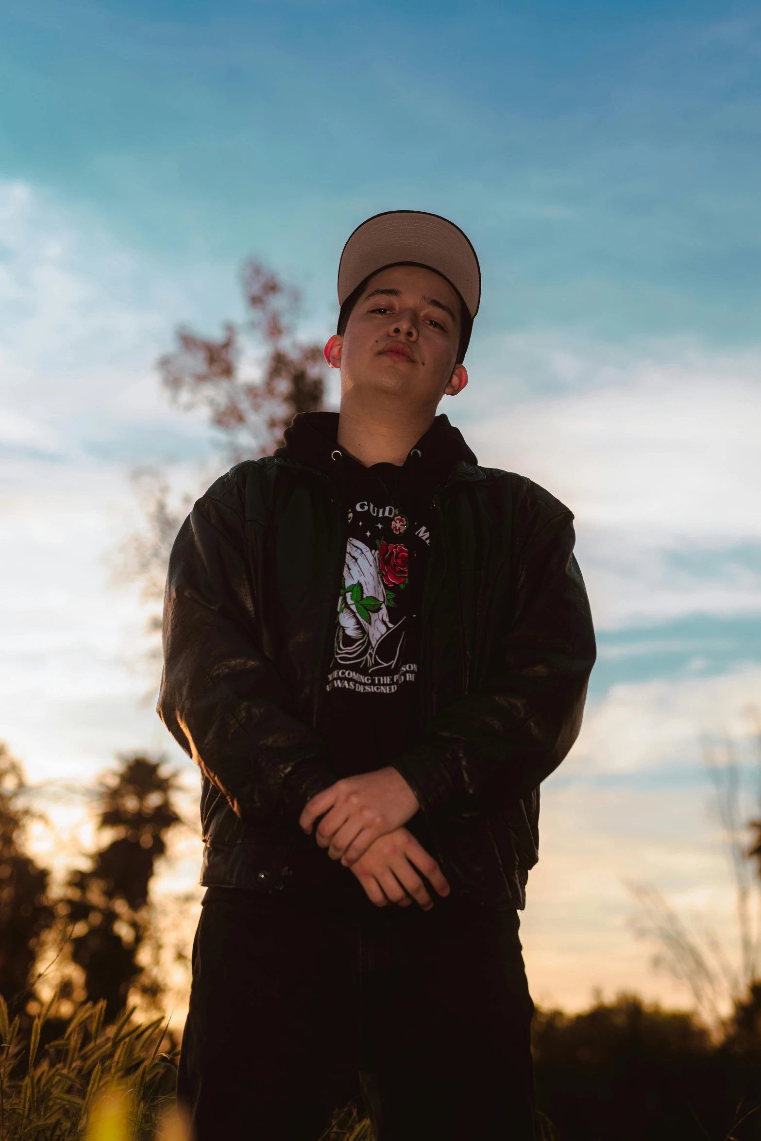 the young man standing outside poses for the camera