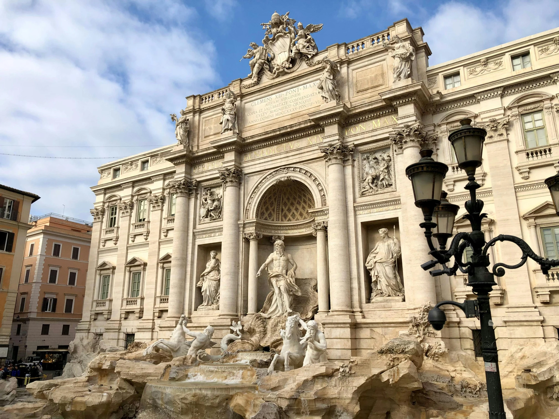 many statues and lights are in front of an ornate building