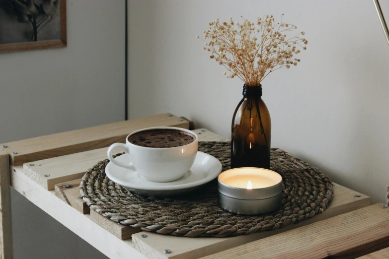 an arrangement of tea lights and a drink on a tray