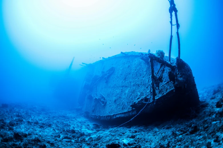 the large boat in the deep ocean has rope on it's side