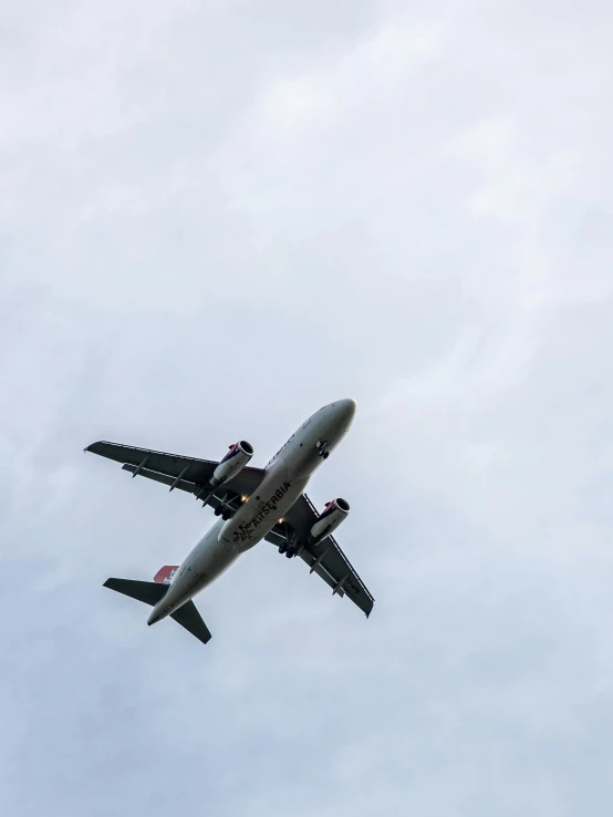 a large passenger jet flying through a cloudy sky