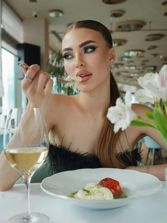 a young woman with food and a wine glass