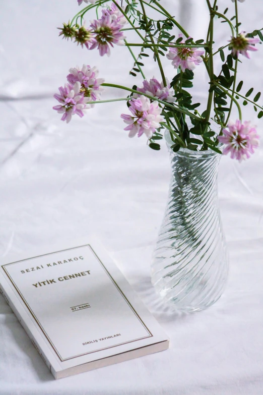 a glass vase with a flower inside of it