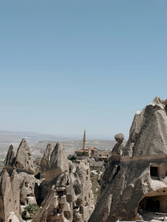 an area with large rock formations and a tower in the background