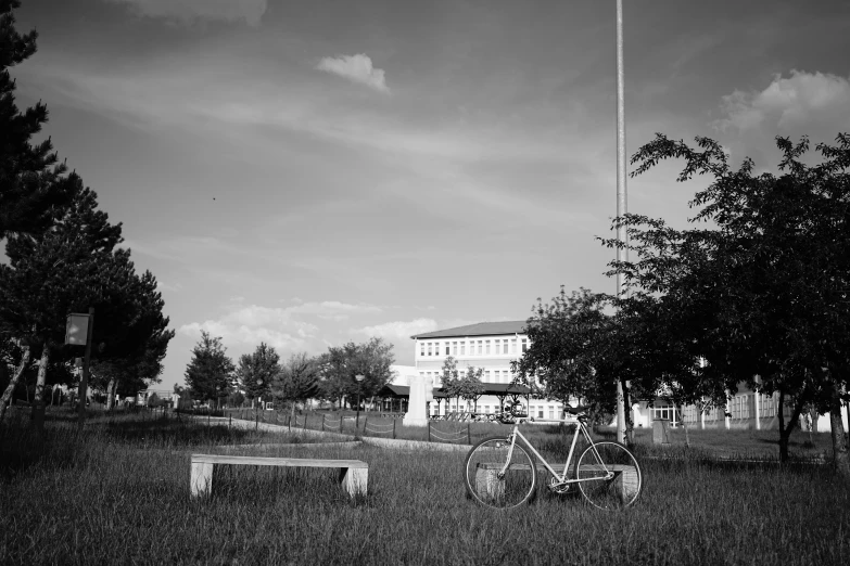 a bike and a bench are outside in the dark