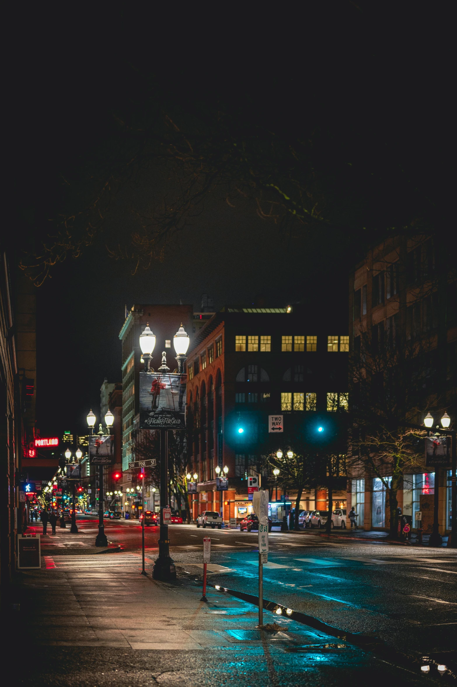 city street with a red traffic light on a dark night