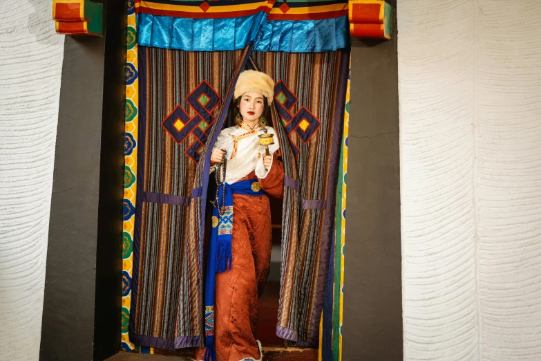 an image of an indian woman in front of a curtain