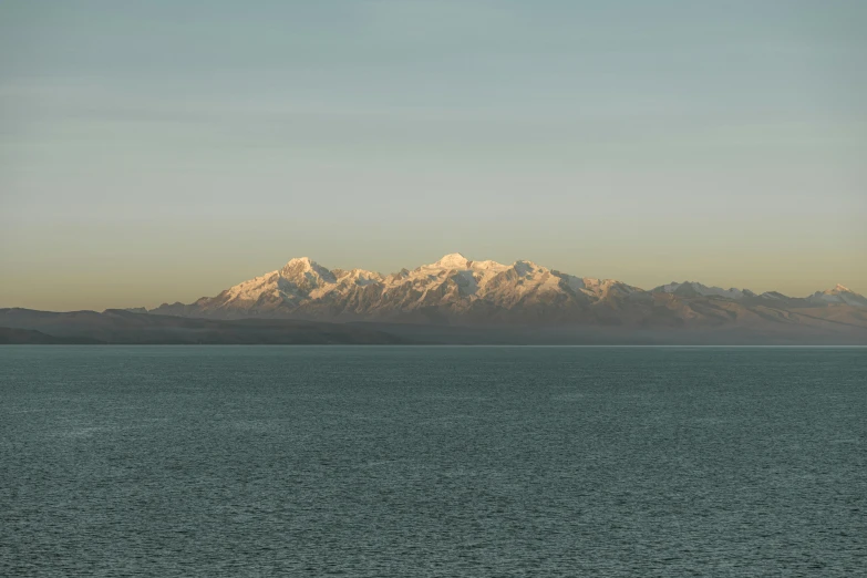 the mountains are seen on top of the water