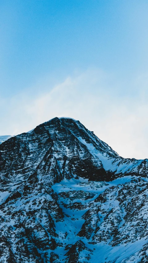 snow covered mountains and clouds in the distance