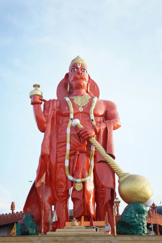 a large statue of a man with a rope and a bell