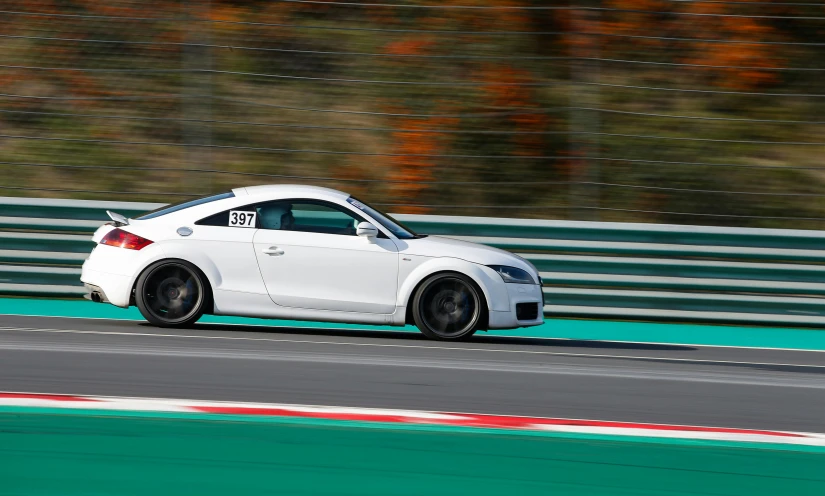 a white sports car on a race track