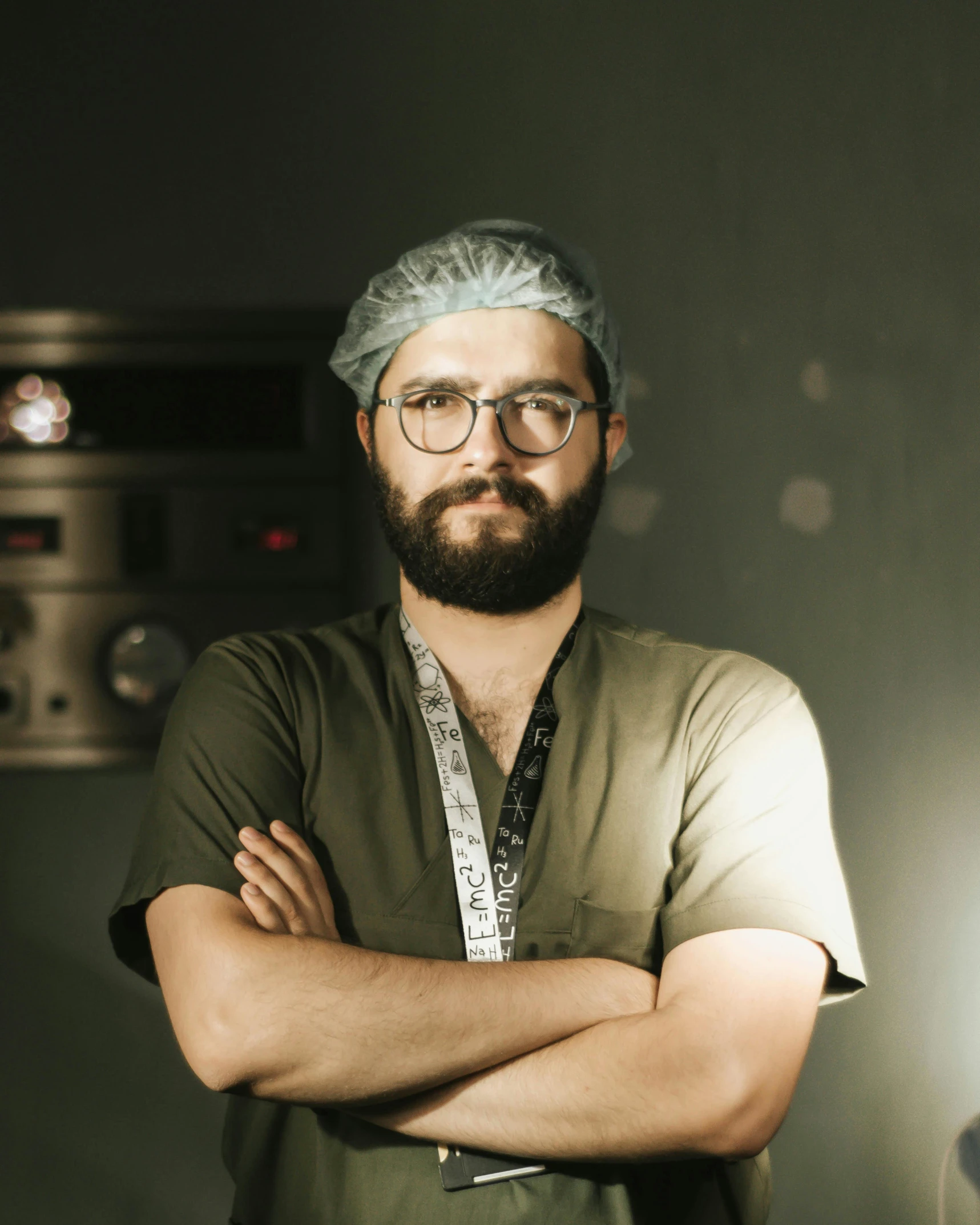 a bearded man in a green scrubroom poses for a po