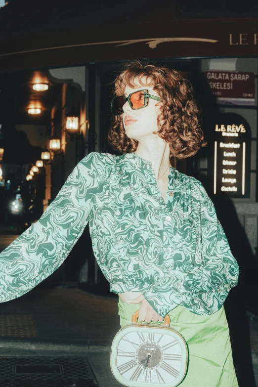 a young woman in glasses walking down the street