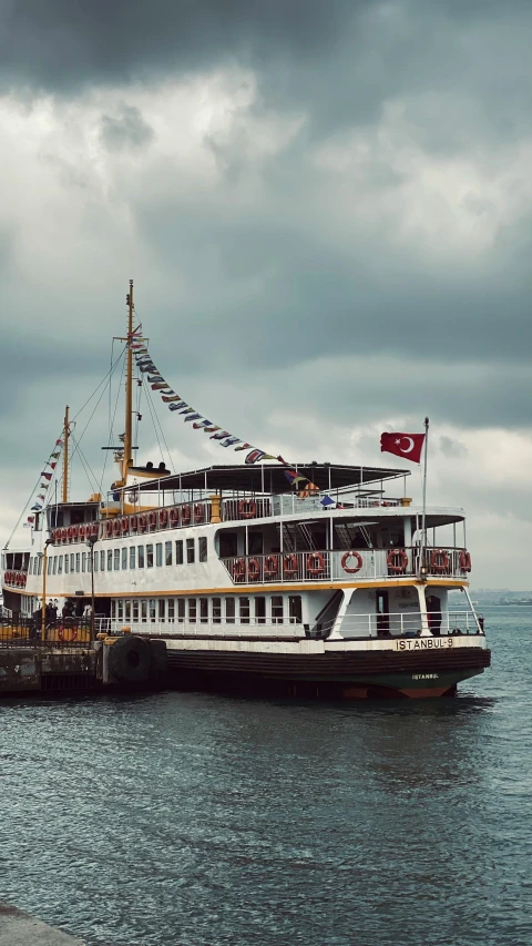 a white boat in water with many people on it