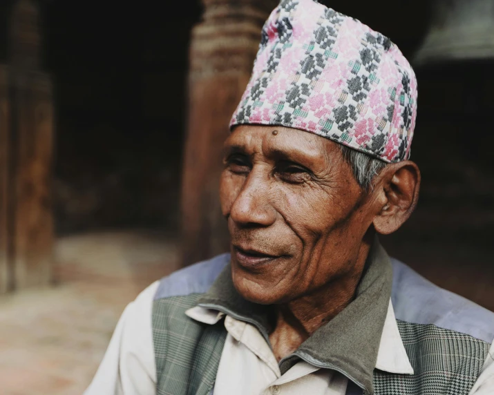 the older man is wearing an elaborate hat