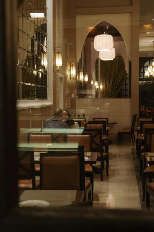 a man sitting at a table alone in a restaurant