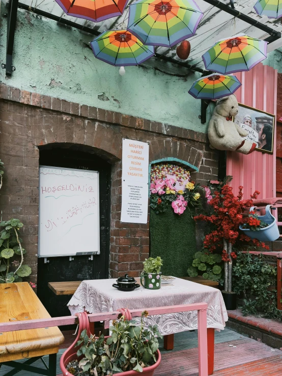 a table with flowers on it outside near an outdoor cafe