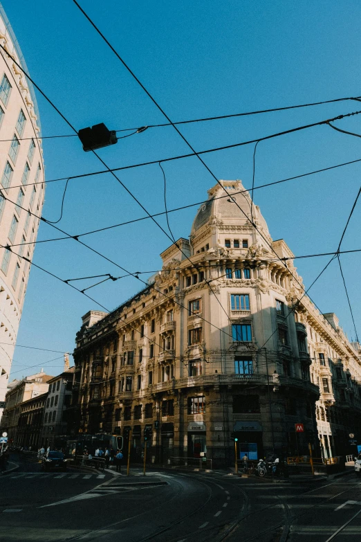 the sky above some buildings and wires in the street