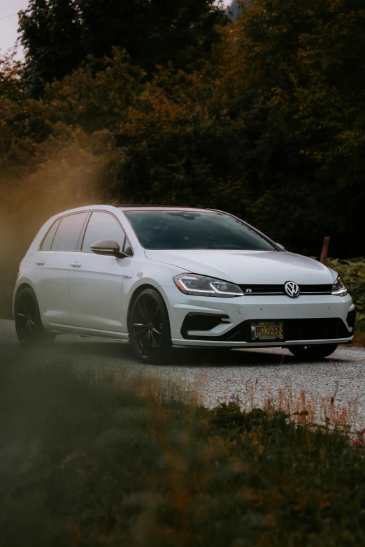 a white volkswagen estate wagon driving on a road