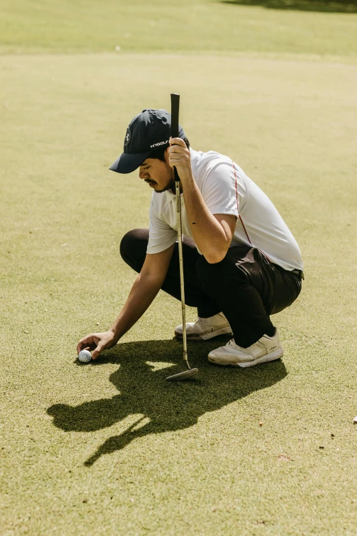 man sitting on the ground with his foot on a tennis racket