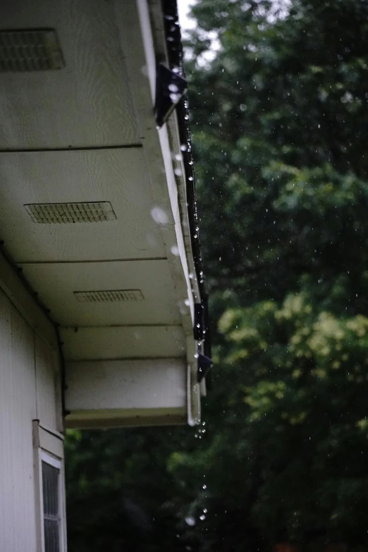 a close up of the corner of a house with rain