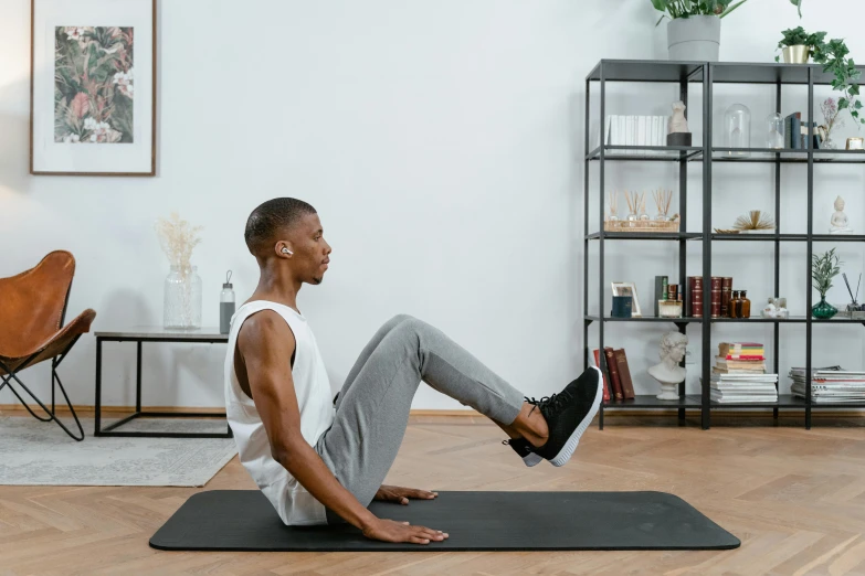 a man doing a plank stretch on a yoga mat